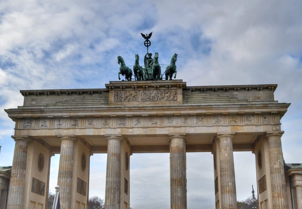 The Brandenburg gate is one of the most popular tourist places in berlin with it's marbled columns and green chariot and horses on top
