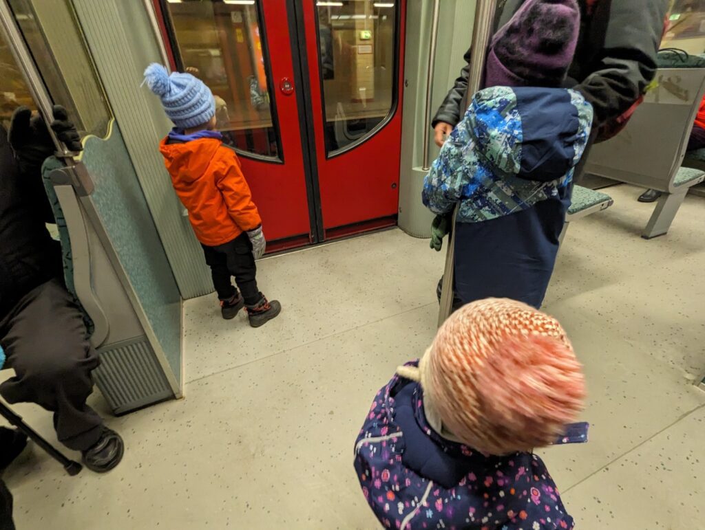 3 children riding the Ubahn in Berlin