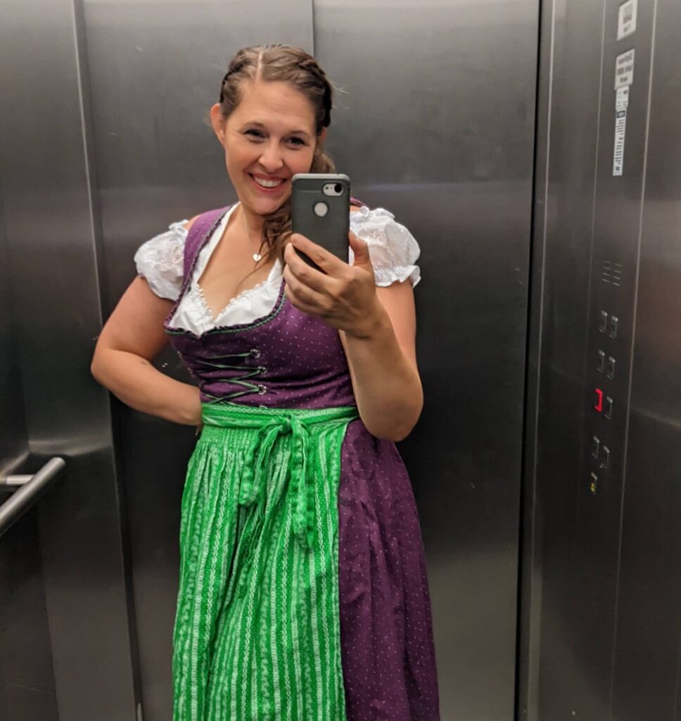 girl wearing dirndl in germany using cellphone