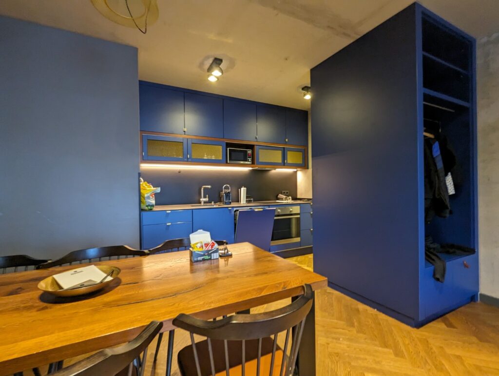 Great Berlin Apartment rental that included a full kitchen. Blue cupboards and carpentry and wood kitchen table