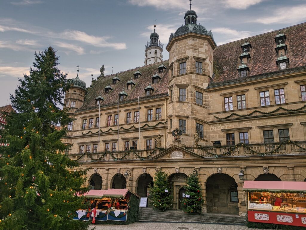 the christmas markets in rothenburg with a green christmas tree in front of the Rathaus