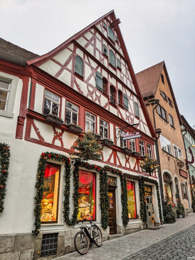 The germany christmas town (rothenburg ob der tauber) decorated for christmas with garland and lights on a fachwerkhaus