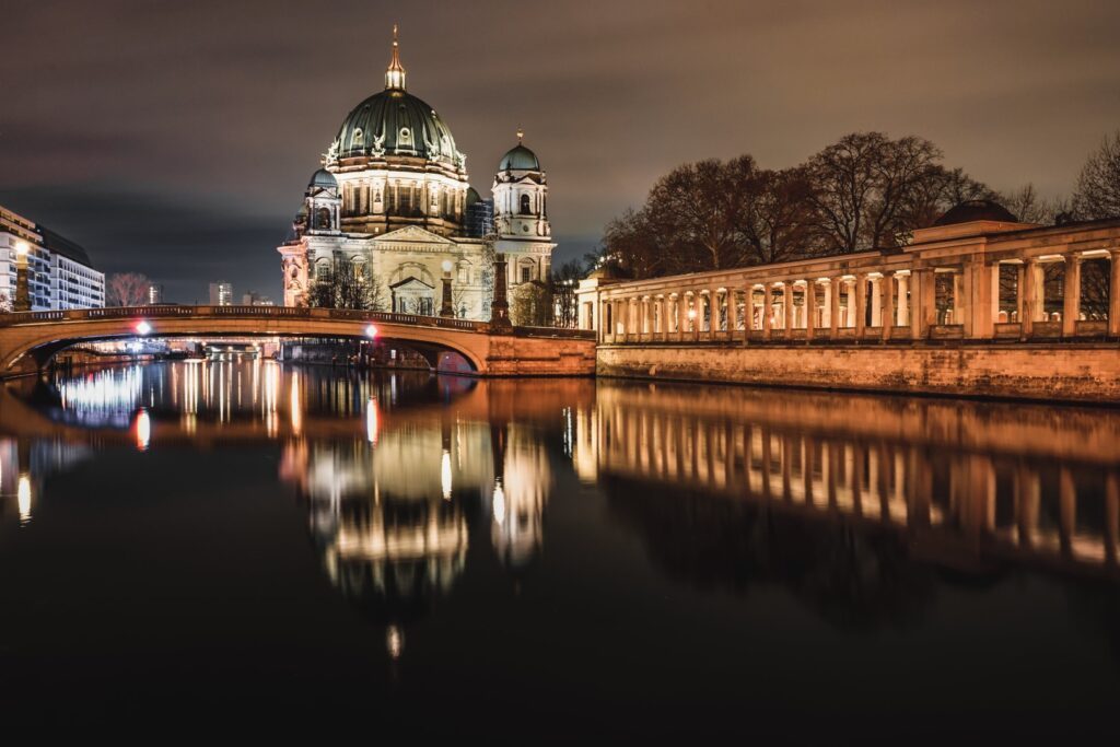 Berlin cathedral and columnade at night with the reflection in the spree river