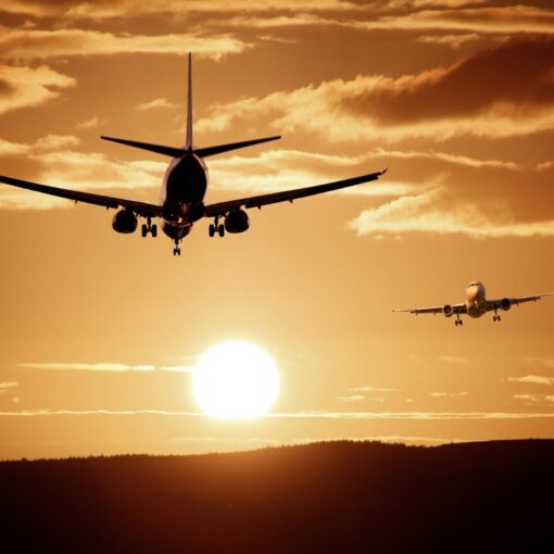 2 planes flying in a sunset sky