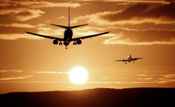 2 planes flying in a sunset sky