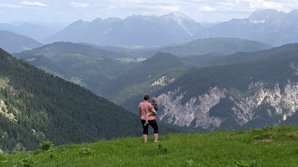 mother holding son looking out over the bavarian alps
