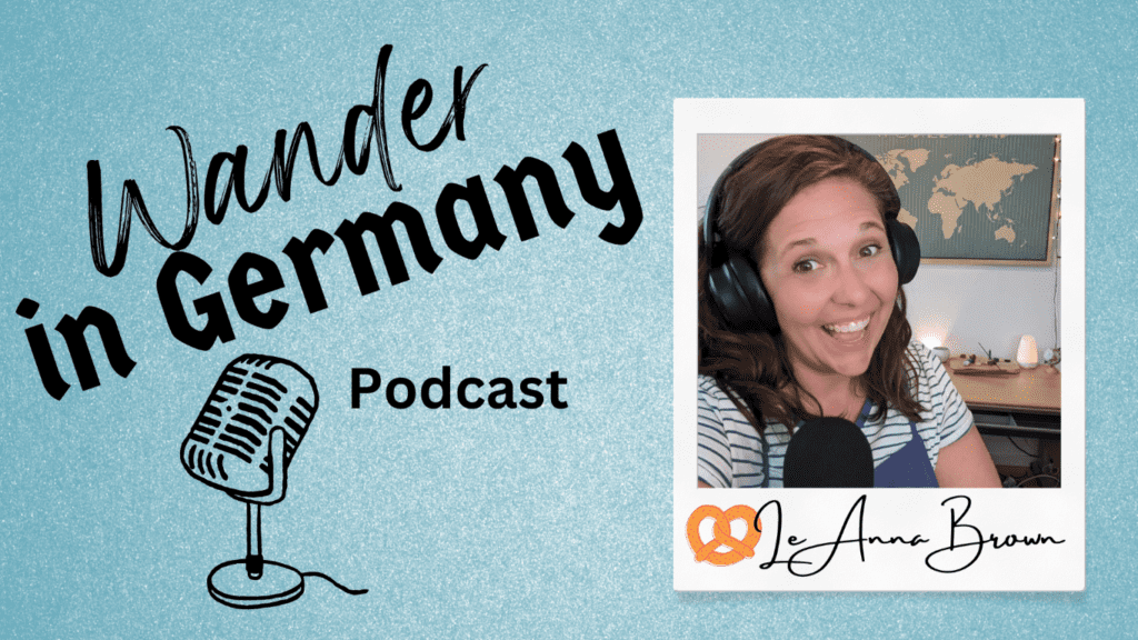 Blue background with black text of Wander in Germany Podcast with photo of LeAnna Brown wearing headphones and smiling