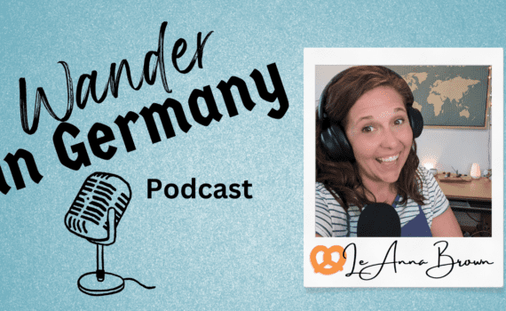 Blue background with black text of Wander in Germany Podcast with photo of LeAnna Brown wearing headphones and smiling